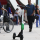 A Lime dockless electric scooter is parked on a Wilshire Boulevard sidewalk, available for its next rider, on July 9, 2018 in Los Angeles, California.